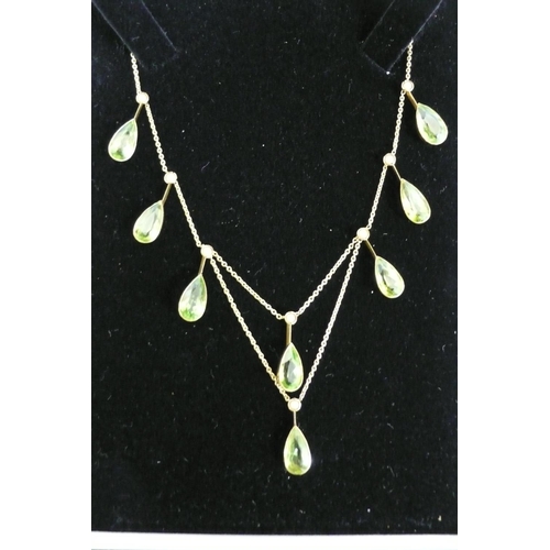 177 - 15ct gold pear shaped peridot and seed pearl necklace (eight peridots, length 10mm each)