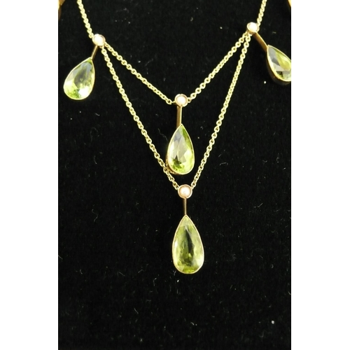 177 - 15ct gold pear shaped peridot and seed pearl necklace (eight peridots, length 10mm each)