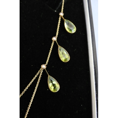 177 - 15ct gold pear shaped peridot and seed pearl necklace (eight peridots, length 10mm each)