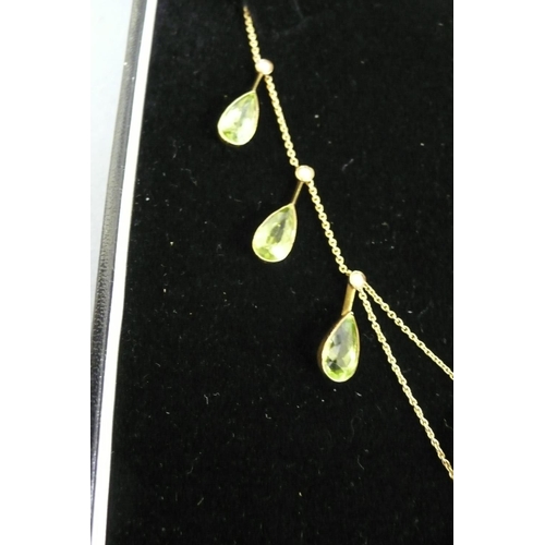 177 - 15ct gold pear shaped peridot and seed pearl necklace (eight peridots, length 10mm each)