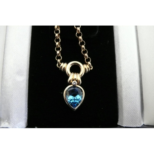 179 - 14ct gold necklace with pear drop blue topaz and diamond pendant. Total weight 8.6grms