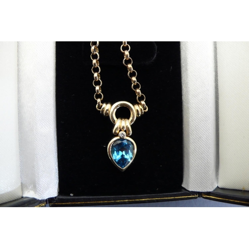 179 - 14ct gold necklace with pear drop blue topaz and diamond pendant. Total weight 8.6grms