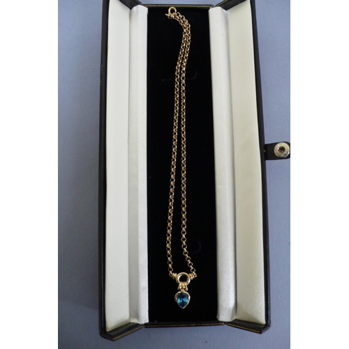 179 - 14ct gold necklace with pear drop blue topaz and diamond pendant. Total weight 8.6grms