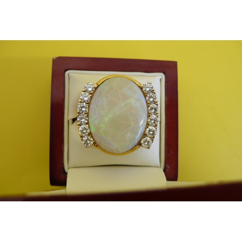 61 - An Impressive Large Oval Opal and Twelve Stone Diamond Ring Set in 18ct Gold. 
2.39ct of Diamonds, O... 