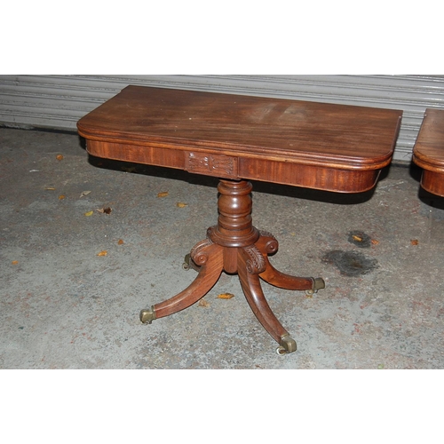 74 - Pair of W IV Mahogany swivel top folding tea tables with turned columns and quadruple sabre legs and... 