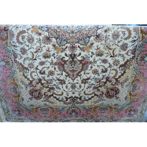 427 - A good quality Persian silk and wool mix carpet with floral decoration in multicoloures 8ft X 5ft 6i... 