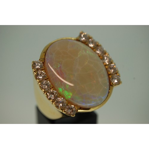 61 - An Impressive Large Oval Opal and Twelve Stone Diamond Ring Set in 18ct Gold. 
2.39ct of Diamonds, O... 