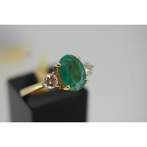 176 - An 18ct Gold oval emerald and diamond three stone ring (Emerald 1-26cts) Size N