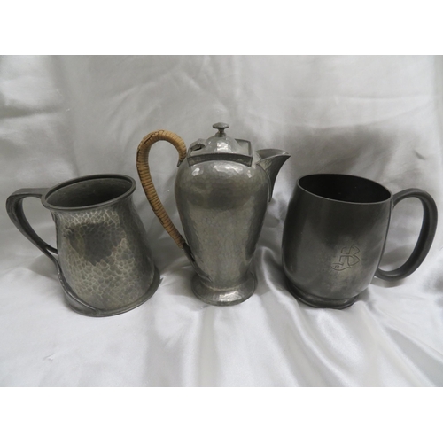 118 - Archibald Knox for Liberty & Co.
Two Tudric pewter pint tankards and a hot water jug.
Numbers 066, 0... 