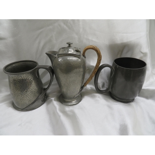 118 - Archibald Knox for Liberty & Co.
Two Tudric pewter pint tankards and a hot water jug.
Numbers 066, 0... 