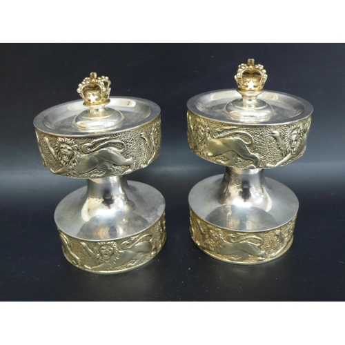 243 - Pair of Anthony Elson designed parcel Britannia silver gilt pepper grinders with Regal decoration ma... 