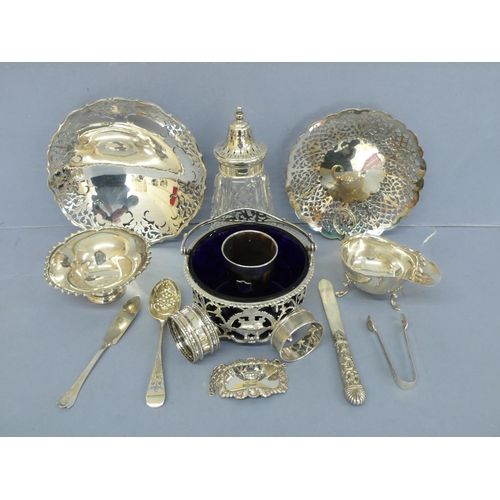 10 - A collection of silver, three pierced bon bon dishes one swing handled, small comport, sauceboat, si... 