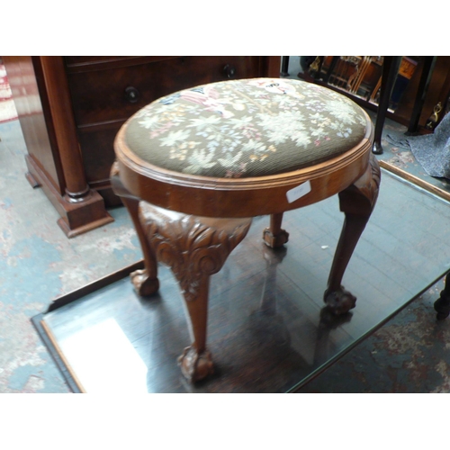 110 - Oval carved walnut stool with needlework top, cabriole legs with ball and claw feet