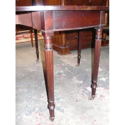 111 - Circular drop leaf mahogany dining table in the style of Gillow with turned tapering reeded legs and... 