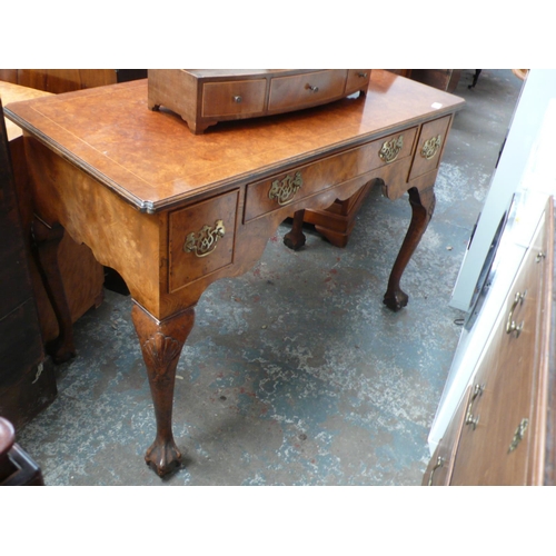 118 - Georgian style burr walnut three drawer dressing table on cabriole legs with ball and claw feet