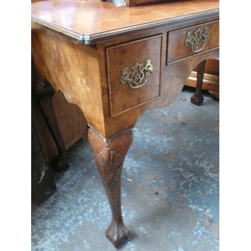 118 - Georgian style burr walnut three drawer dressing table on cabriole legs with ball and claw feet