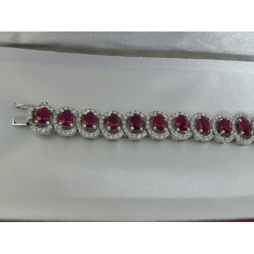 133 - 18ct white gold graduated ruby and diamond cluster bracelet, approx 12cts of rubies and 2.5cts of di... 