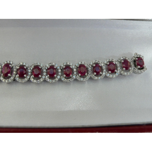 133 - 18ct white gold graduated ruby and diamond cluster bracelet, approx 12cts of rubies and 2.5cts of di... 