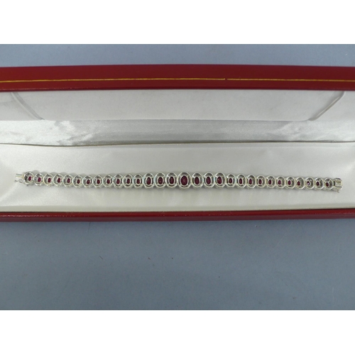 133 - 18ct white gold graduated ruby and diamond cluster bracelet, approx 12cts of rubies and 2.5cts of di... 