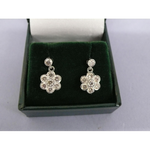 135 - Pair of 18ct white gold flower shaped diamond drop earrings, diamonds approx 1.5cts