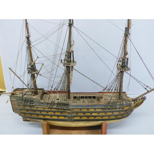 138 - A Victorian wooden model of H.M.S. Victory (some damage), length 20ins plus six postcards