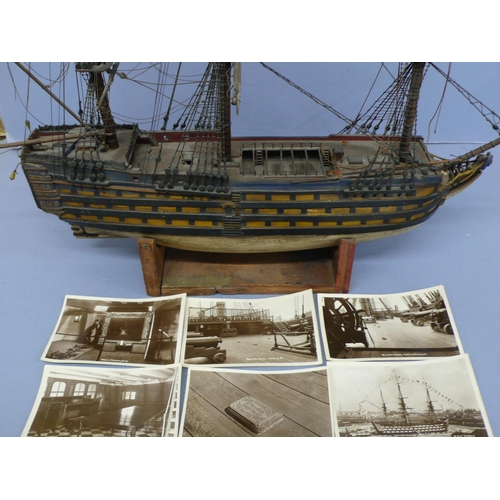 138 - A Victorian wooden model of H.M.S. Victory (some damage), length 20ins plus six postcards