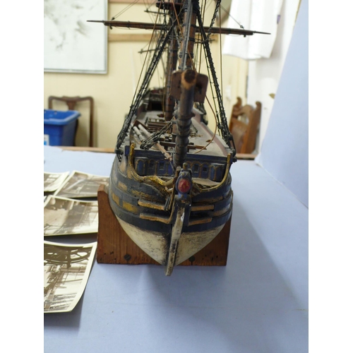 138 - A Victorian wooden model of H.M.S. Victory (some damage), length 20ins plus six postcards