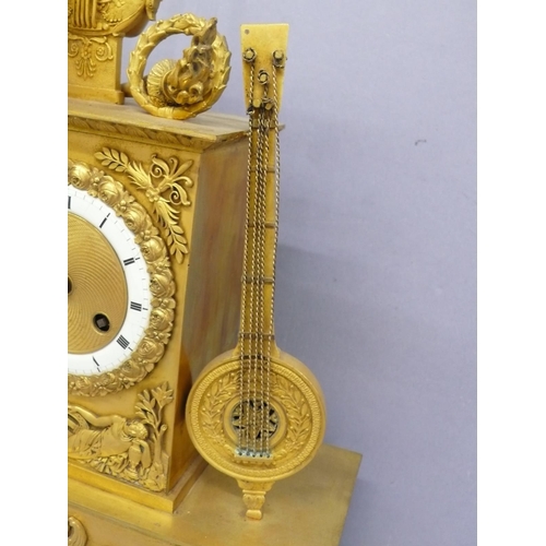 140 - An early 19thC French ormolu mantel clock with figure playing a lyre to top, white enamel chapter ri... 