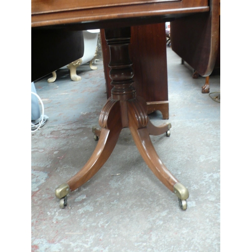 162 - 19thC mahogany Pembroke table with two drawers, one false, turned column, sabre legs and brass casto... 