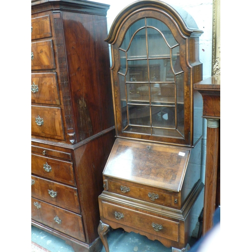 166 - Small reproduction walnut bureau bookcase with two drawers below, fitted interior on carved cabriole... 