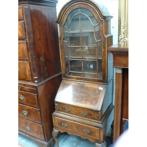 166 - Small reproduction walnut bureau bookcase with two drawers below, fitted interior on carved cabriole... 