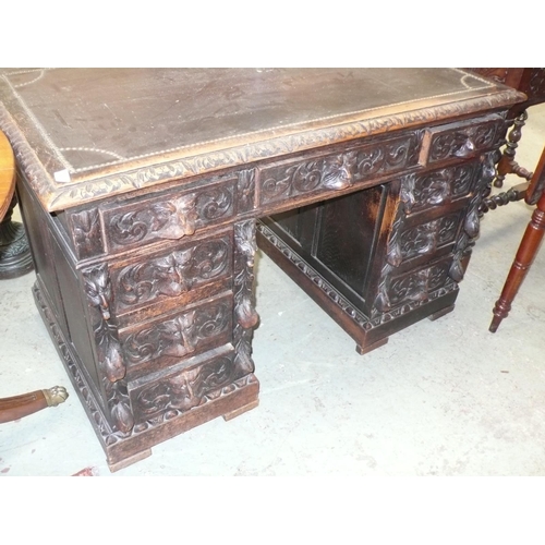 174 - Victorian carved oak twin pedestal desk with lion mask handles, nine drawers