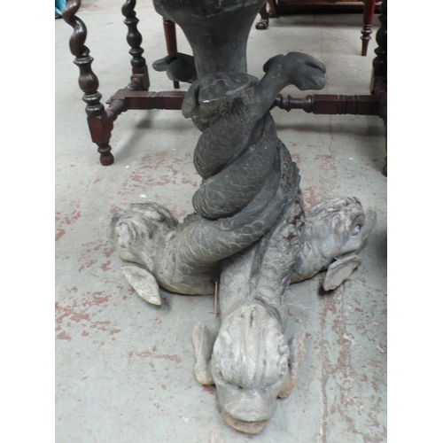 176 - A lead bird bath in the form of three dolphins with twisted tails holding a circular fluted dish abo... 