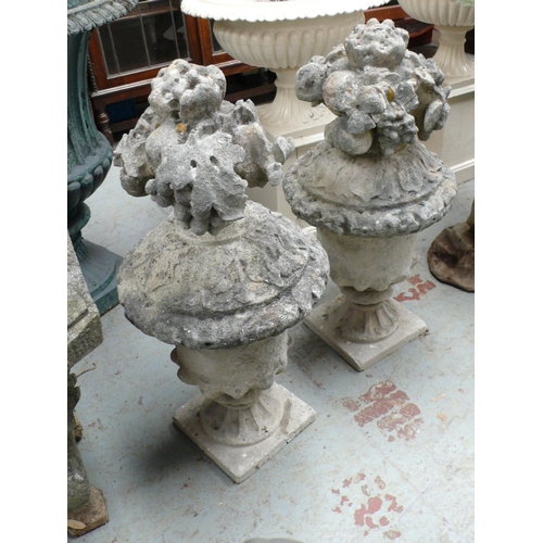 189 - Pair of Portland stone finials in the form of urns with fruit - height 29 ins