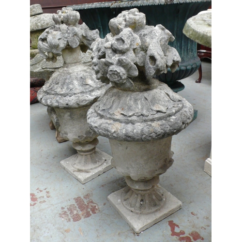 189 - Pair of Portland stone finials in the form of urns with fruit - height 29 ins