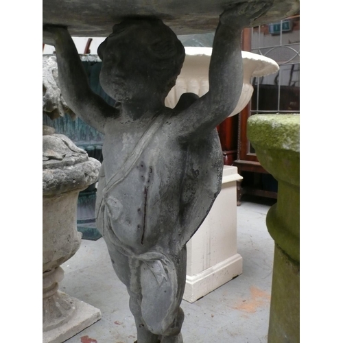 190 - A lead sun dial in the form of a cherub holding a dial aloft with a separate concrete base - height ... 