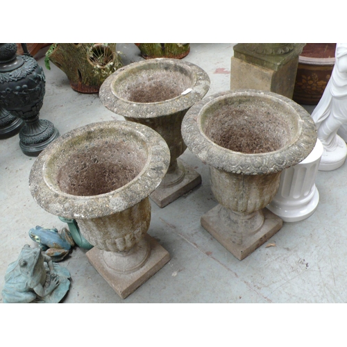 195 - Three concrete fluted garden urns matching lot 192