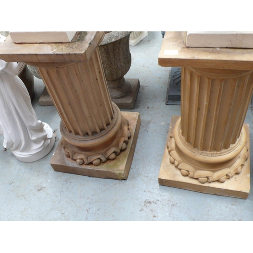 205 - A pair of terracotta columns on square bases - height 28.5 ins approx