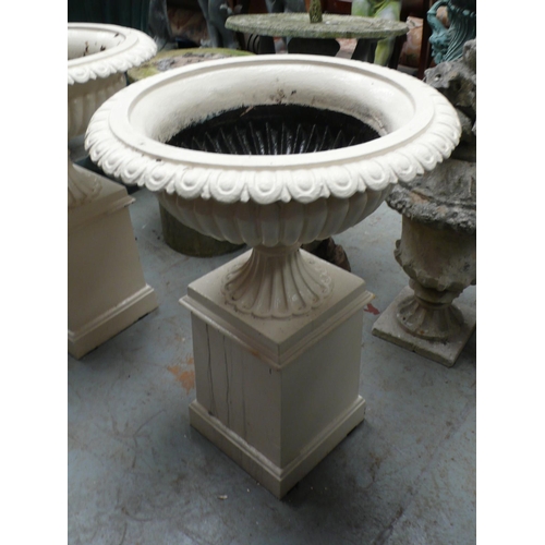 207 - A pair of cast iron fluted campana urns on square pedestals - height 28 ins approx, diameter 21 ins ... 