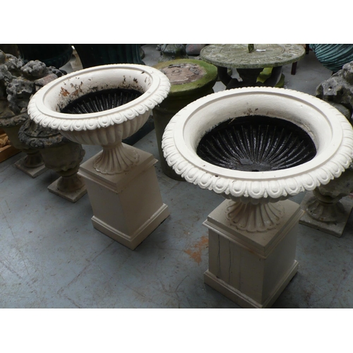 207 - A pair of cast iron fluted campana urns on square pedestals - height 28 ins approx, diameter 21 ins ... 