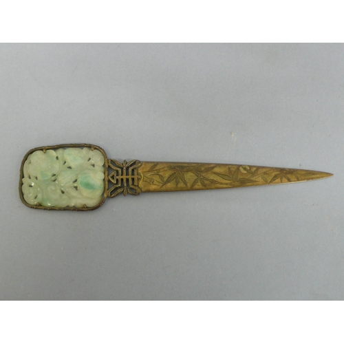 22 - 19th/20thC Chinese gilt metal letter opener with pale green carved pierced jade panel to top, showin... 