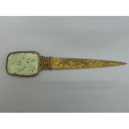 22 - 19th/20thC Chinese gilt metal letter opener with pale green carved pierced jade panel to top, showin... 