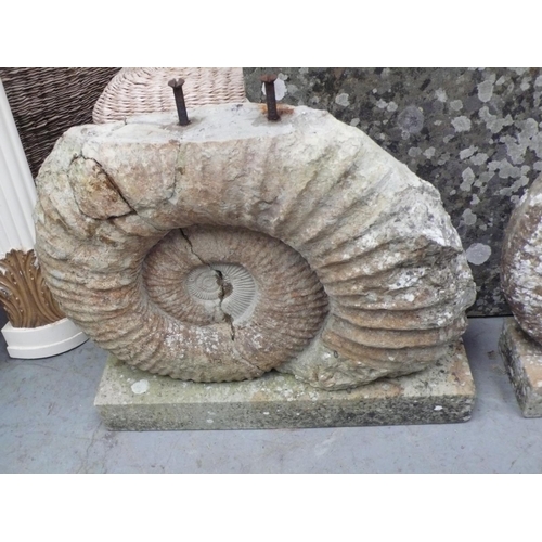 220 - A garden rectangular table made from limestone with carved amonite pedestal bases, 25x34x21ins