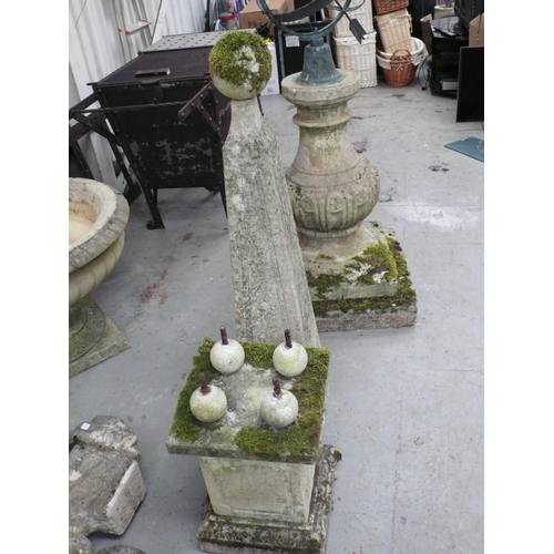 221 - A pair of carved stone obelisks with ball finials, square tapering column, four ball supports on ste... 