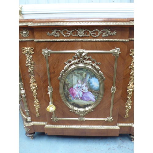 223 - A French quarter veneered gilt metal mounted walnut break fronted demilune side cabinet with oval pa... 