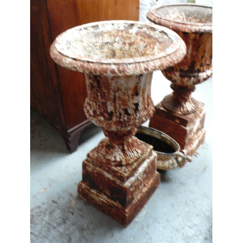 226 - Pair of cast iron fluted garden urns on pedestals, height 27ins, diameter 15ins, plus one