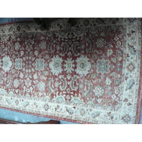 228 - A handmade wool runner with floral decoration in rust and cream wools, 185x37ins