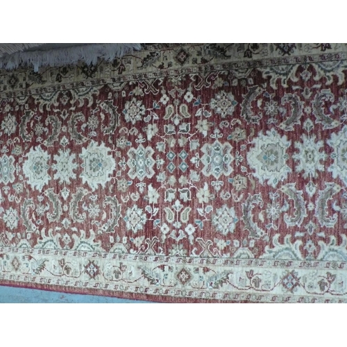 228 - A handmade wool runner with floral decoration in rust and cream wools, 185x37ins