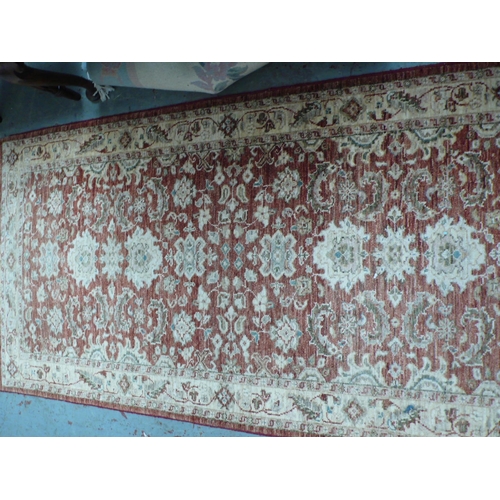 228 - A handmade wool runner with floral decoration in rust and cream wools, 185x37ins