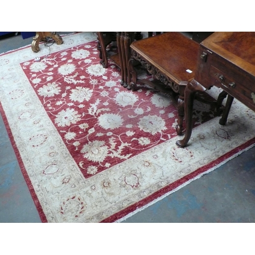 232 - Large wool carpet in red and beige wools with floral decoration, 102x78ins